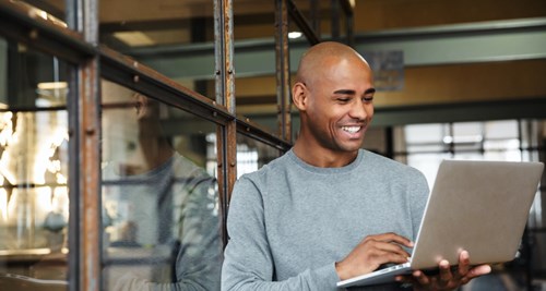 Man using laptop while standing